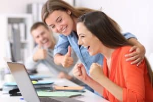 Happy,Employee,Being,Congratulated,By,Colleagues,After,Success,At,Office